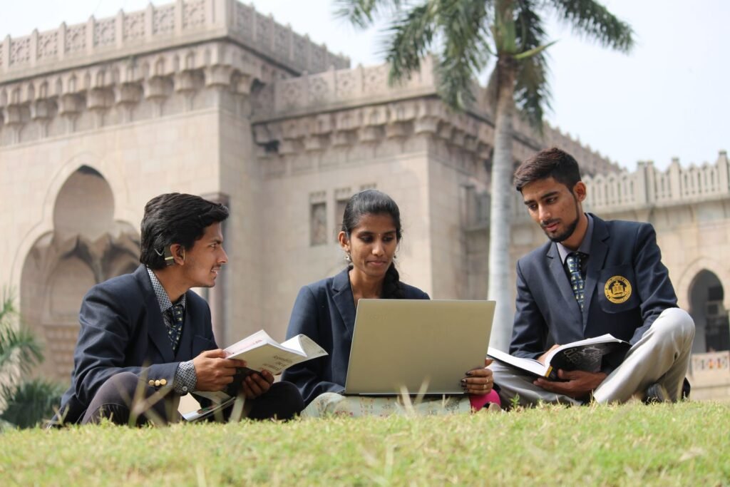Students studying together on a university campus lawn