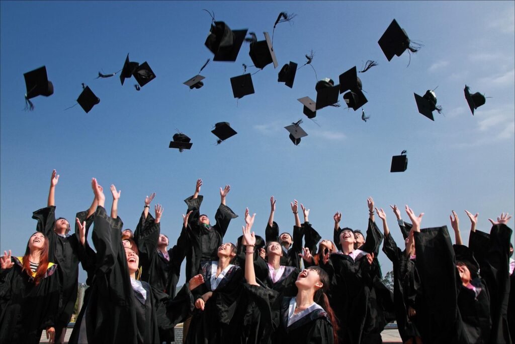 Graduates throwing caps in the air at a graduation ceremony