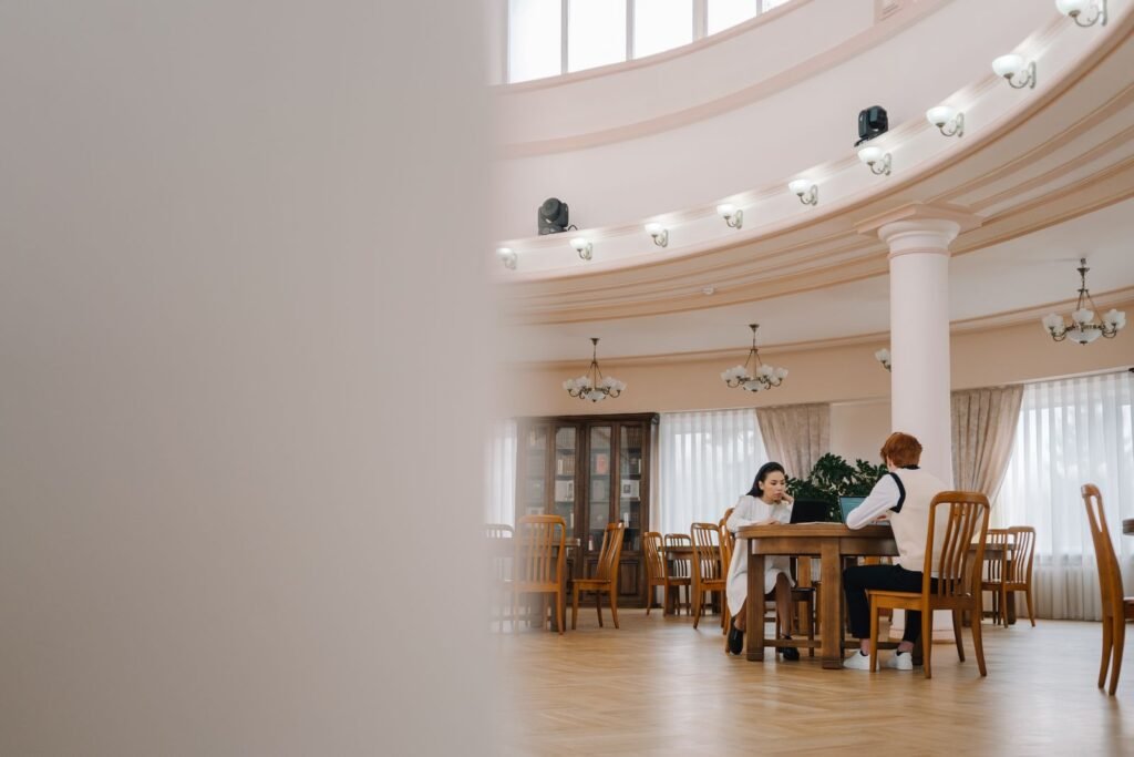 International college students using laptops in a library