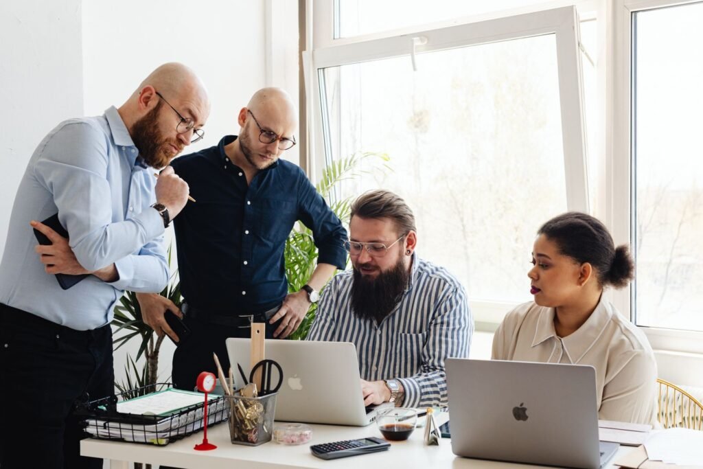 Marketing team reviewing a student recruitment plan on a laptop